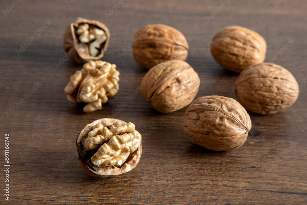 Peeled walnuts and whole walnuts in wooden table
Peeled walnuts and whole walnuts in wooden table