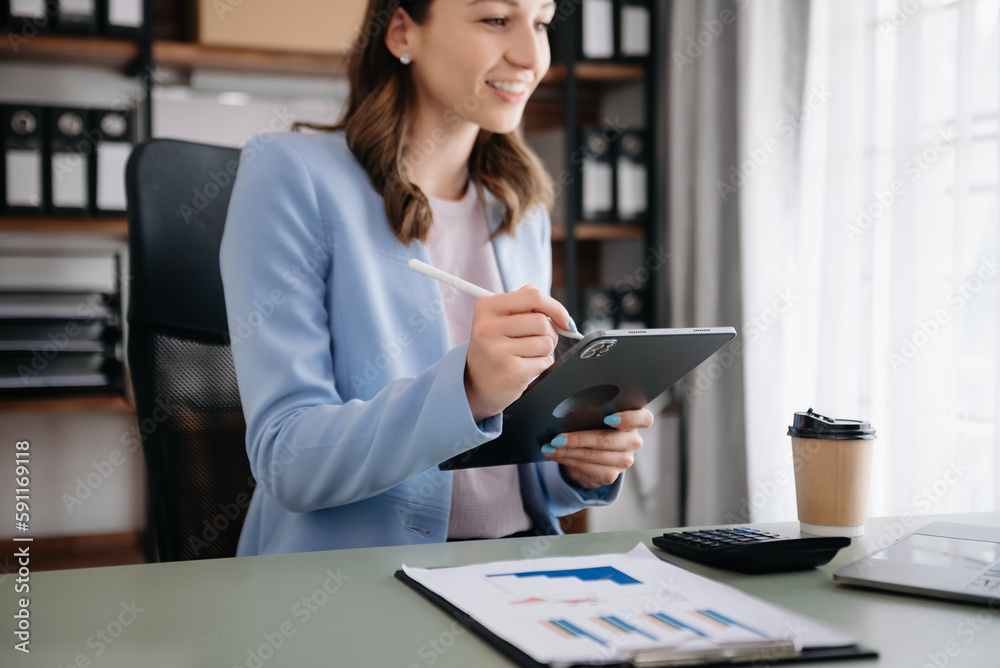 Confident woman with a smile standing holding notepad and tablet at the modern office... Confident woman with a smile standing holding notepad and tablet at the modern office...