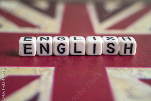 Word English on United Kingdom flag, learning English language courses concept.