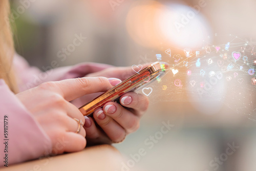 Female hands using mobile phone with city mall in bokeh on background