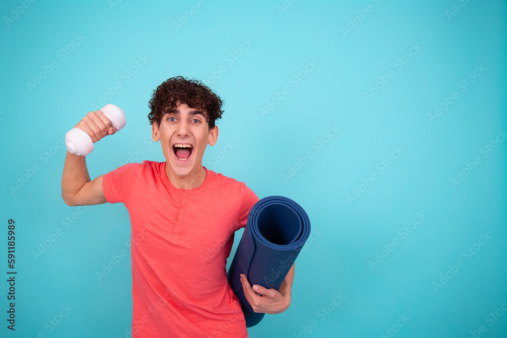 Funny handsome guy is engaged in fitness. Blue background.