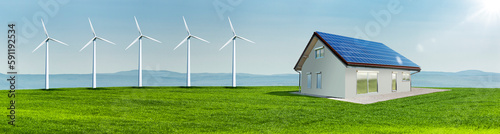 Windräder und Solarzellen auf einem Hausdach auf einer Grünen Wiese in einer ...