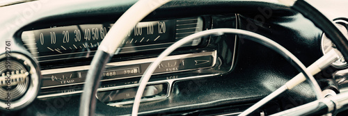 Detail of a classic american car with steering wheel and dashboard