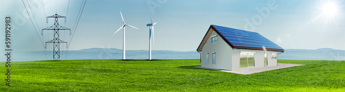 Windräder und Solarzellen auf einem Hausdach auf einer Grünen Wiese in einer ...