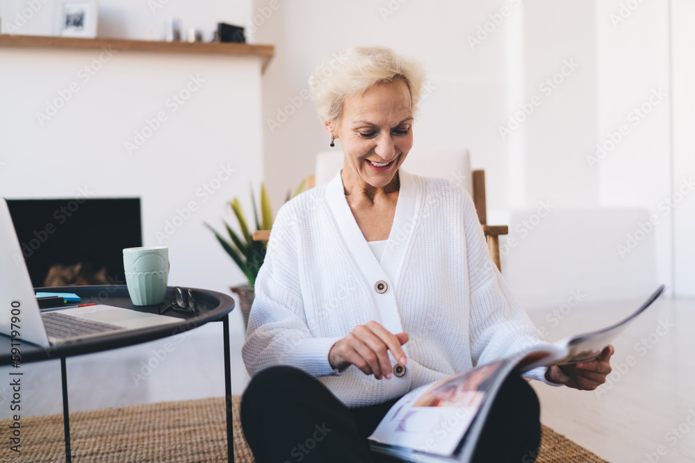 Cheerful senior woman reading magazine at home Cheerful senior woman reading magazine at home