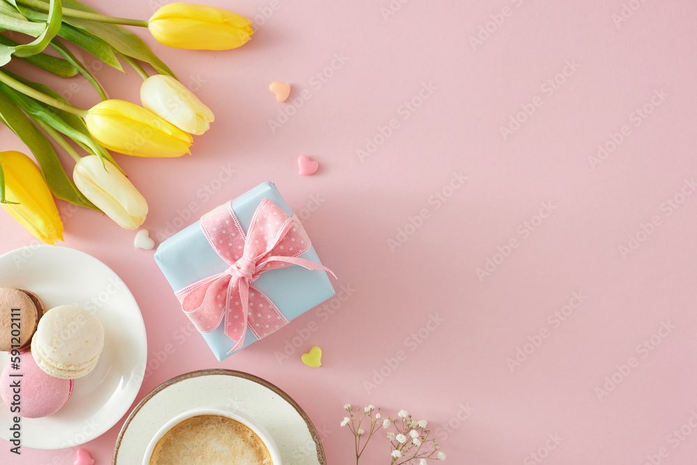 Women's Day celebration concept. Top view photo of gift box cup of coffee macaroons small hearts bunch of yellow white tulips and gypsophila flowers on pastel pink background with copyspace