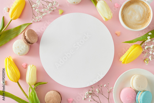 Mother's Day celebration idea. Top view photo of white circle cup of coffee plate with macaroons hearts baubles yellow tulips and gypsophila flowers on pastel pink background