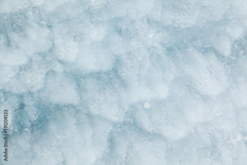 Frozen, uneven, icy texture, close-up. Rough ice.