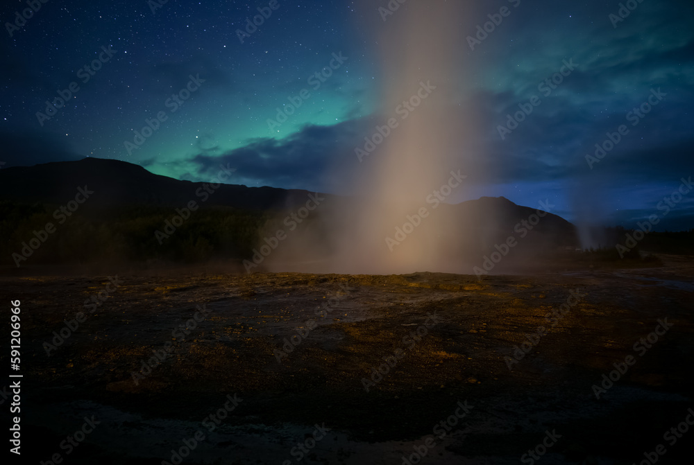Geyser erupting in front of Aurora borealis, Geysir Iceland