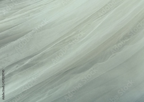 Grey off white coloured textured voile fabric background with space for copy