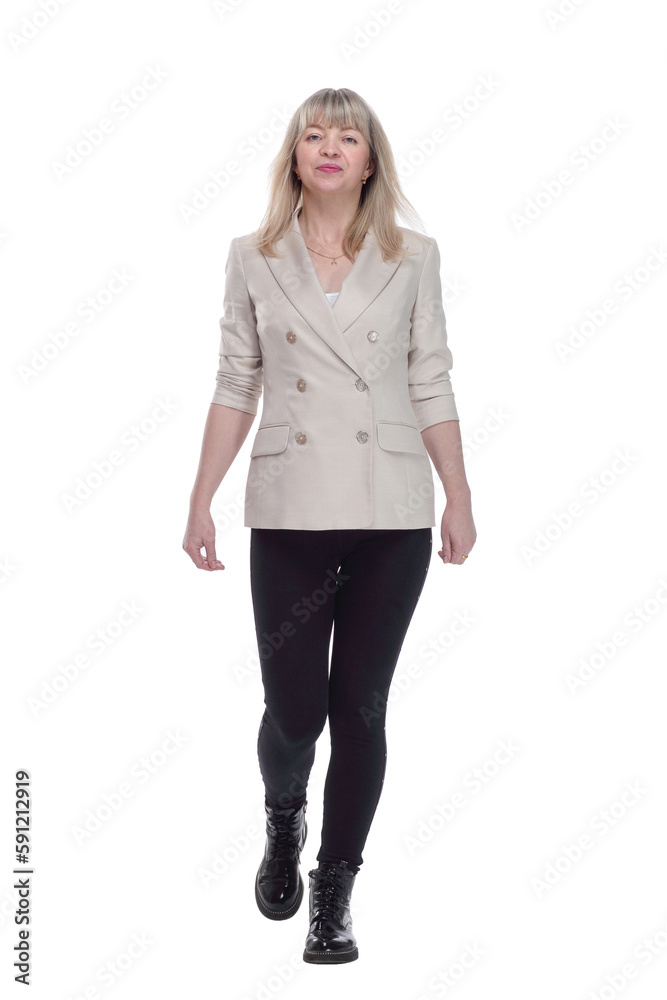 casual woman in a white jacket striding forward. casual woman in a white jacket striding forward.
