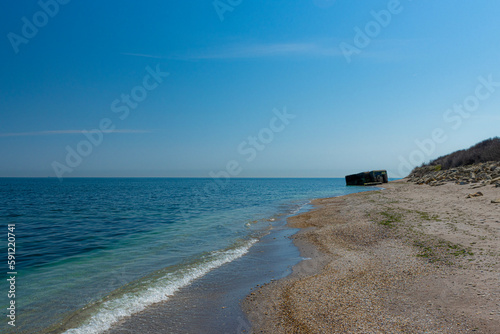 The bunker on the seashore stands as a stark reminder of the tumultuous history of the Second World War. photo