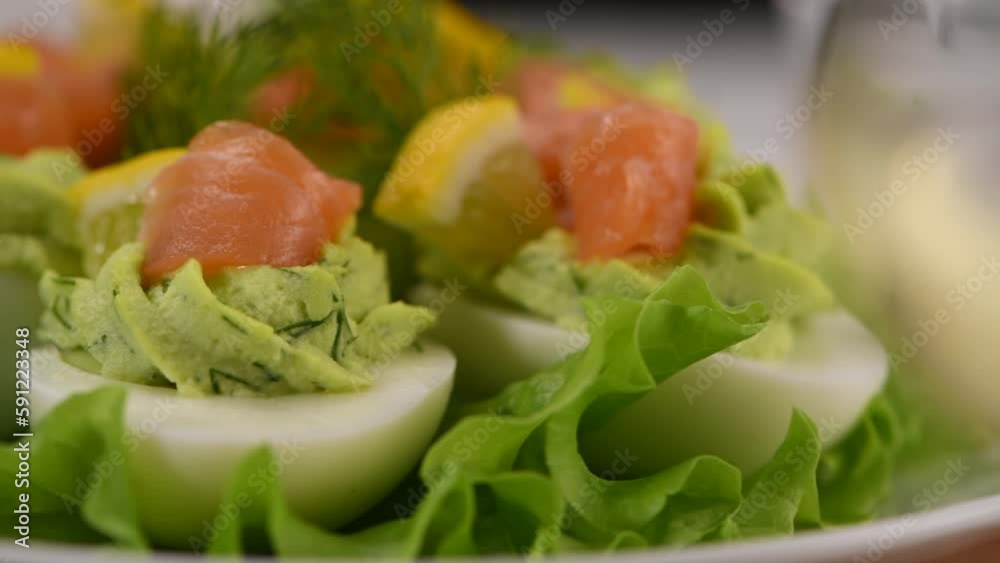 Eggs stuffed with avocado, salmon and lemon. The perfect appetizer for your holiday table. Eggs stuffed with avocado, salmon and lemon. The perfect appetizer for your holiday table.