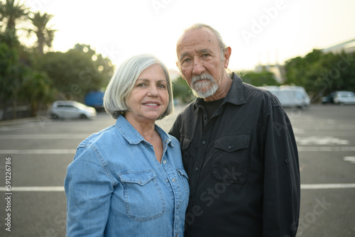Senior man and woman looking at camera