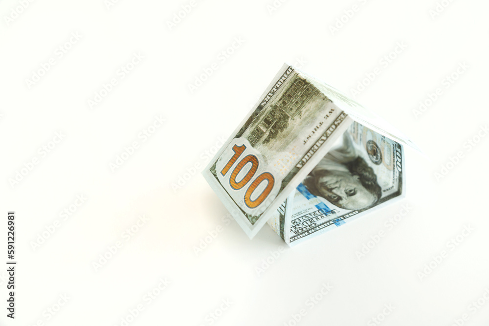 House Shape Made from 100 Dollar Bills over White Background House Shape Made from 100 Dollar Bills over White Background