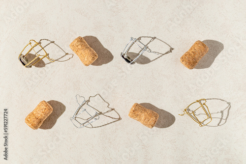 Wallpaper Mural Creative composition made of champagne corks on beige sunlit background with shadow. Bottle caps from sparkling wine and metal wire muselet. Summer party drink concept Torontodigital.ca