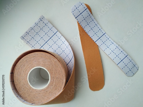 kinesiology tape on white background. Physiotherapy and therapeutic tape for wrist pain, aches and tension. elastic therapeutic tape. adhesive tape and alternative medicine

