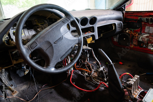 Car interior with disassembled electrics in the garage.