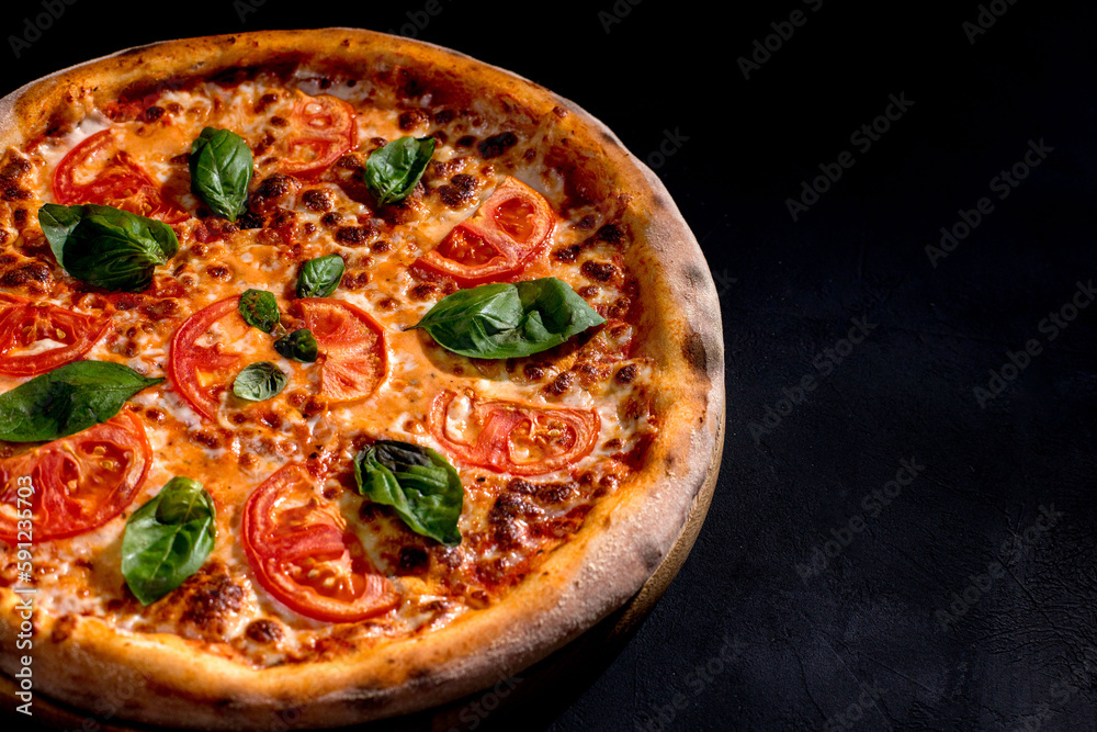 Delicious fragrant pizza with mozzarella, tomatoes and basil with tomato sauce - Margherita