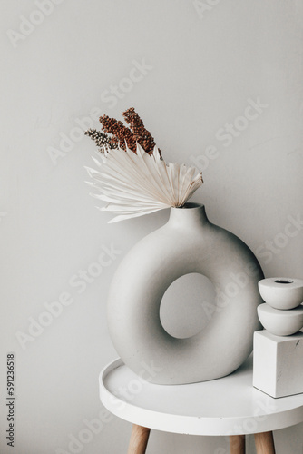 A modern vase with plaster decor in a cozy interior.