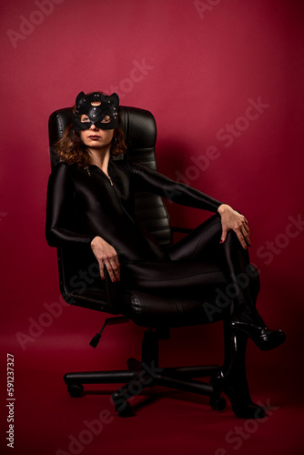 Sexy young woman with black bodysuit and cat mask.