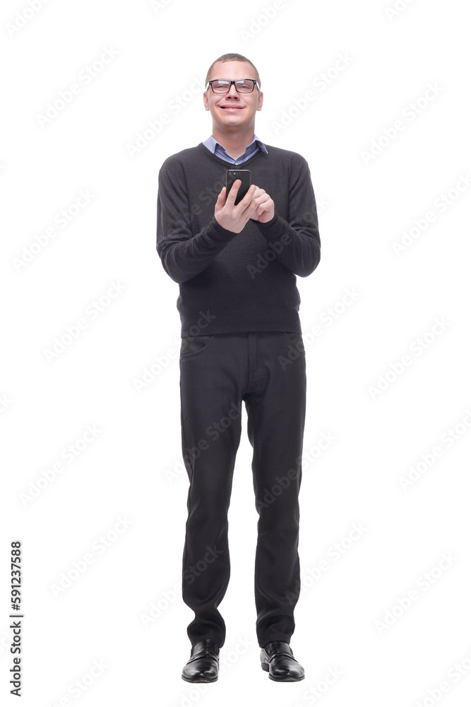 Smiling young man looking at his smart phone while text messaging Smiling young man looking at his smart phone while text messaging