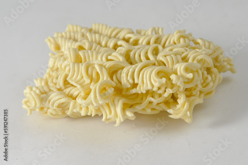 Uncooked instant noodles cut in half isolated on a white background