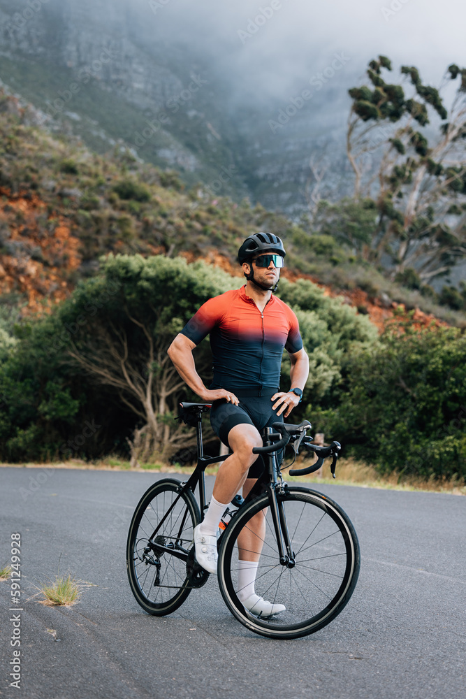 Fototapeta premium Full length of a professional cyclist. Male road bike rider taking a break.