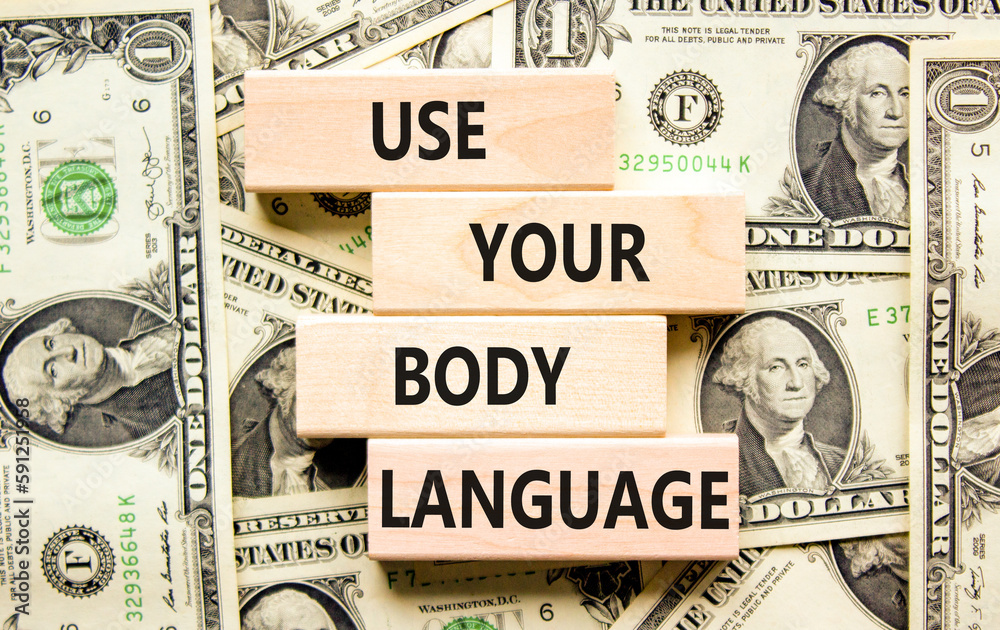 Use your body language symbol. Concept words Use your body language on wooden block. Beautiful background from dollar bills. Motivational business use your body language concept. Copy space.