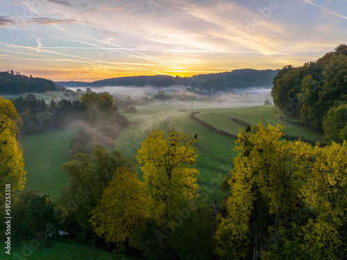 Obraz na płótnie Aerial drone Sunrise view Above autumn colored forest and Valleys in Luxembourg, covered in morning fog w salonie