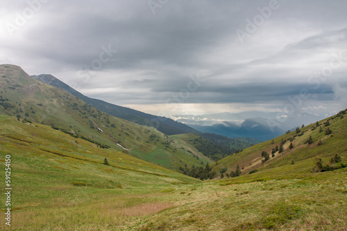 Valley under Maly Krivan, view from mountain pass Bublen, national park Mala Fatra, Slovakia, spring cloudy day.