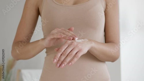 Wallpaper Mural Skincare concept. Unrecognizable young woman applying natural moisturizing cream on hands, standing at home Torontodigital.ca