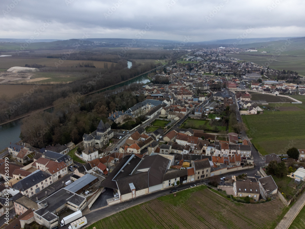 Aerial panoramic winter view on cloudy landscape, hilly vineyards and Marne river near Ay gran cru champagne village, wine production in France