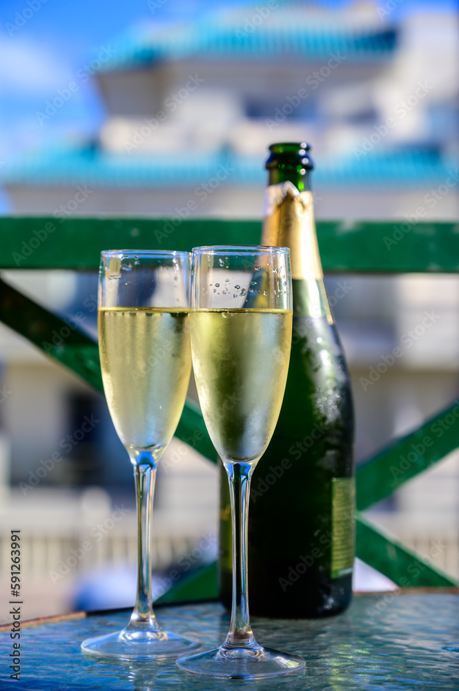 Fototapeta premium Dinner party, drinking of cava or champagne sparkling wine in vacation resort Caleta Fuste, Fuerteventura, Canary islands vacation, Spain