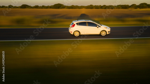 Car driving fast on a road.