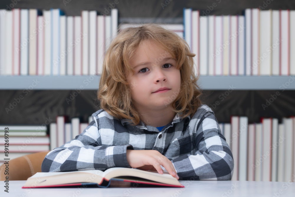 Education, knowledge and bookstore concept. Child reading book in a book store or library, Education, knowledge and bookstore concept. Child reading book in a book store or library,