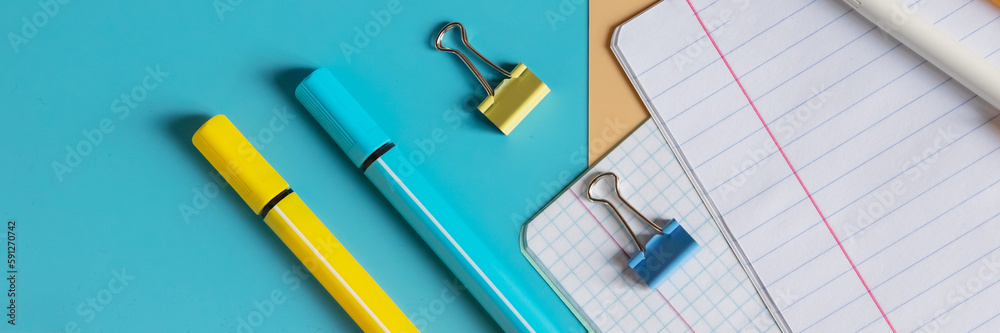 School stationery, color pencils, paints, notepad on blue table. Back to school background. Kids desk top view.School supplies. School stationery, color pencils, paints, notepad on blue table. Back to school background. Kids desk top view.School supplies.