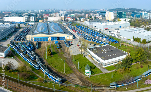 Aerial panorama of a tram depot full of blue tramcars in Krakow, Poland