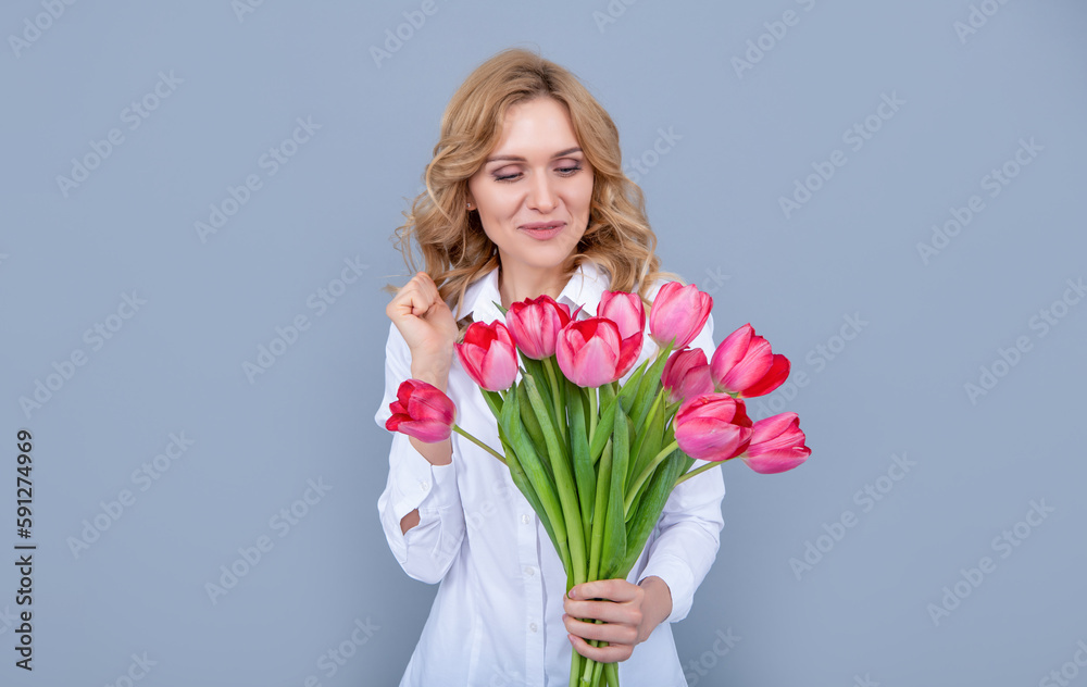 happy young woman with spring tulip bouquet on grey background happy young woman with spring tulip bouquet on grey background