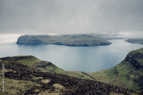 View from the Sornfelli mountain in Faroe Islands to the famous Trollkonufingur, witchs finger on Vagar island, Denmark, Northern Europe photo