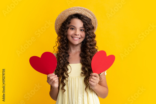 Young teenager child girl with heart shape. Happy Valentines Day. Love and pleasant feelings concept. Happy teenager, positive and smiling emotions of teen girl.