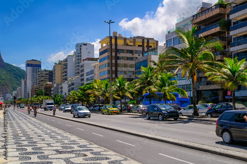 Ipanema with mosaic of sidewalk in Rio de Janeiro, Brazil. Ipanema beach is the most famous beach of Rio de Janeiro, Brazil. Cityscape of Rio de Janeiro. © Ekaterina Belova