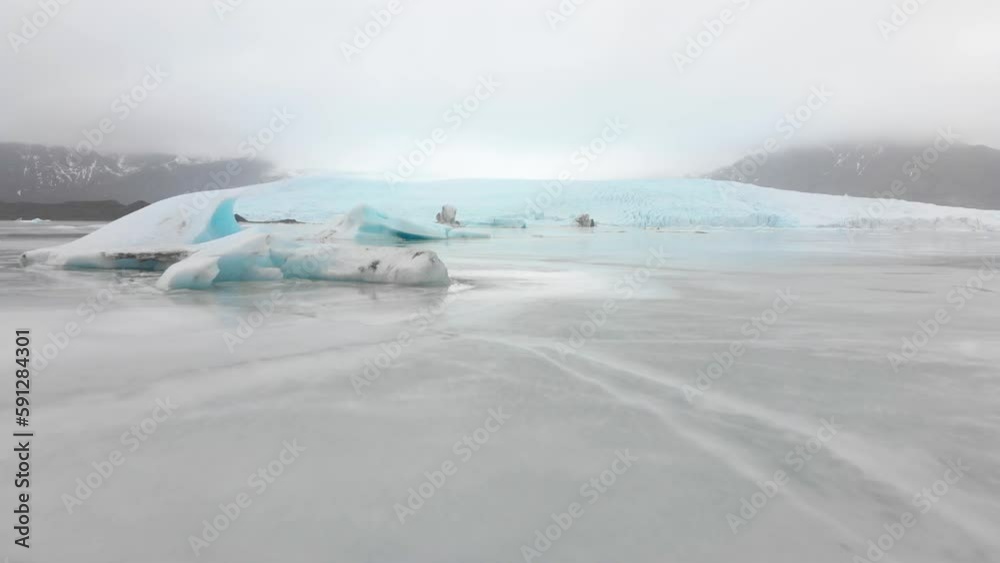 Aerial slow motion rising view Fjallsjokull glacier. The wonderful glacier lagoon of Fjallsárlón in Iceland Aerial slow motion rising view Fjallsjokull glacier. The wonderful glacier lagoon of Fjallsárlón in Iceland