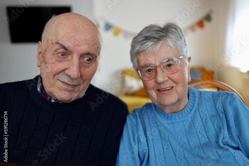 Portrait of grey haired seniors couple looking in camera