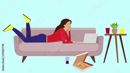 Goblin mode concept. The girl is lying on the couch looking at her laptop, with a pizza box and a glass of soda on the floor. Goblin mode, or a state of indifference, slackness, and refusal to work