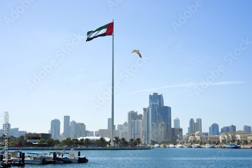 SHARJAH, UAE - February 14, 2023: Flag of the United Arab Emirates in Sharjah on the coastline.