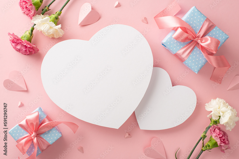 Celebrate Mother's Day in style with top view flat lay photo with gift boxes tied with pink ribbon, delicate carnation flowers, and pink paper hearts on a soft pink background with two hearts for text