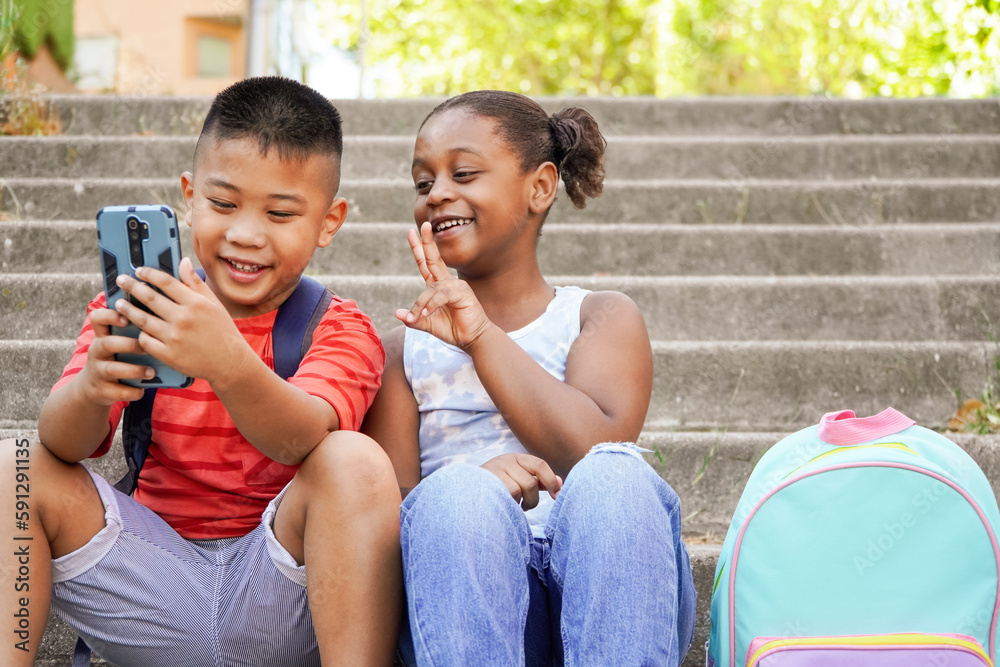 Happy multiethnic children using mobile phone for vlogging. New generations of influencers streaming out social media content, childhood, fun, two Happy multiethnic children using mobile phone for vlogging. New generations of influencers streaming out social media content, childhood, fun, two