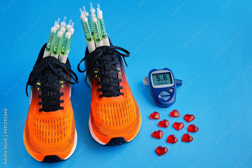 Orange running shoes with insulin syringe pens and a for