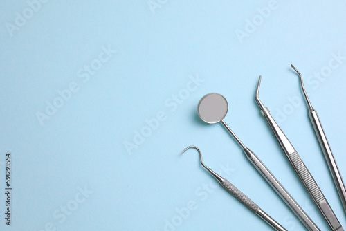 Dentist's instruments on a blue background close up top view 